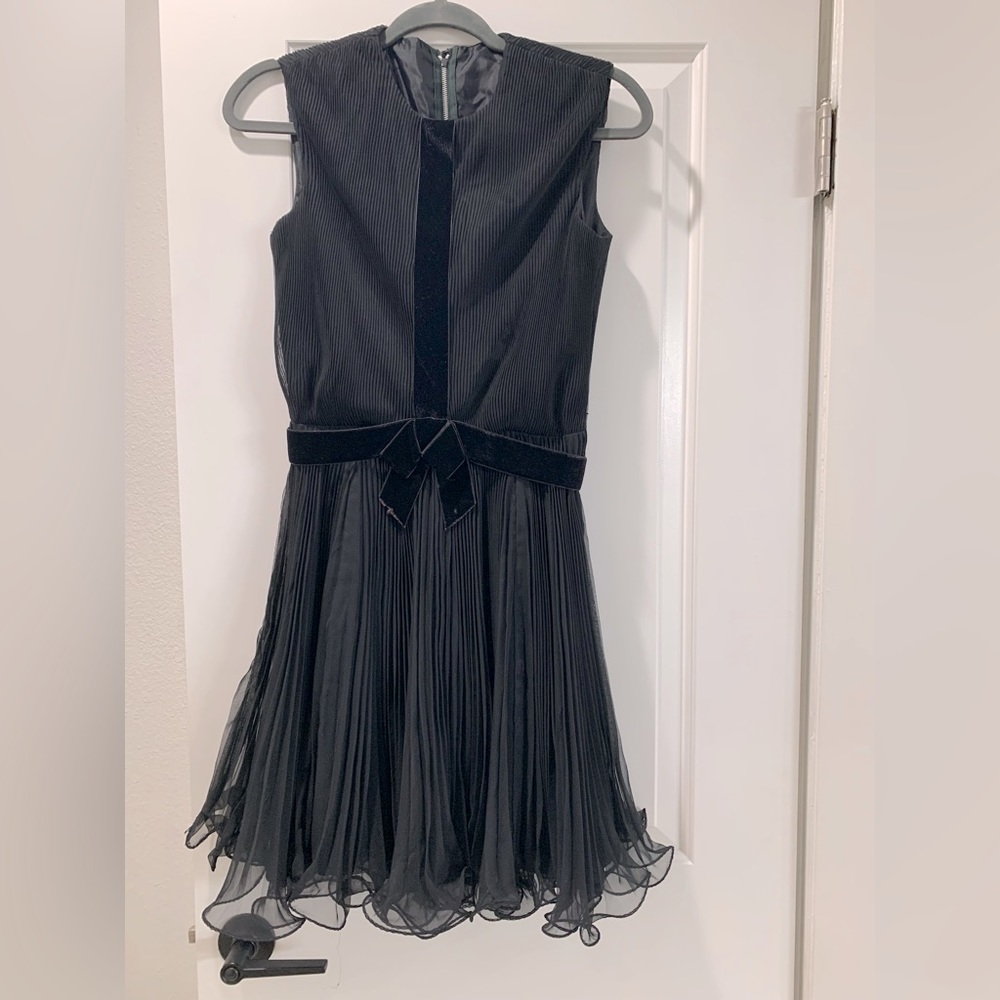 Vintage dress from- adorable flared bottom with velvet bow.